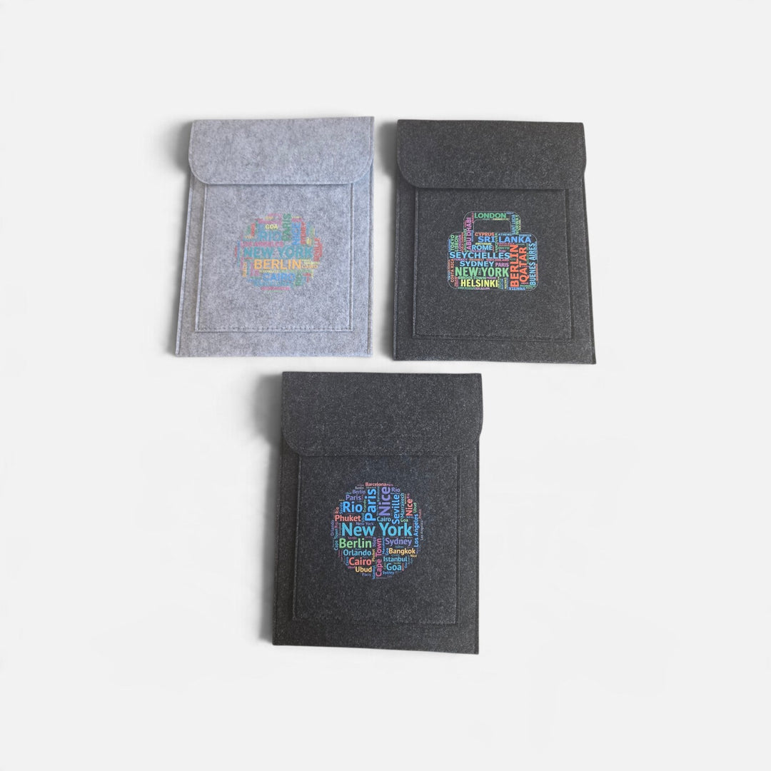 Well Travelled Wallets felt document holders and passport cases in grey and charcoal with travel-themed city prints.