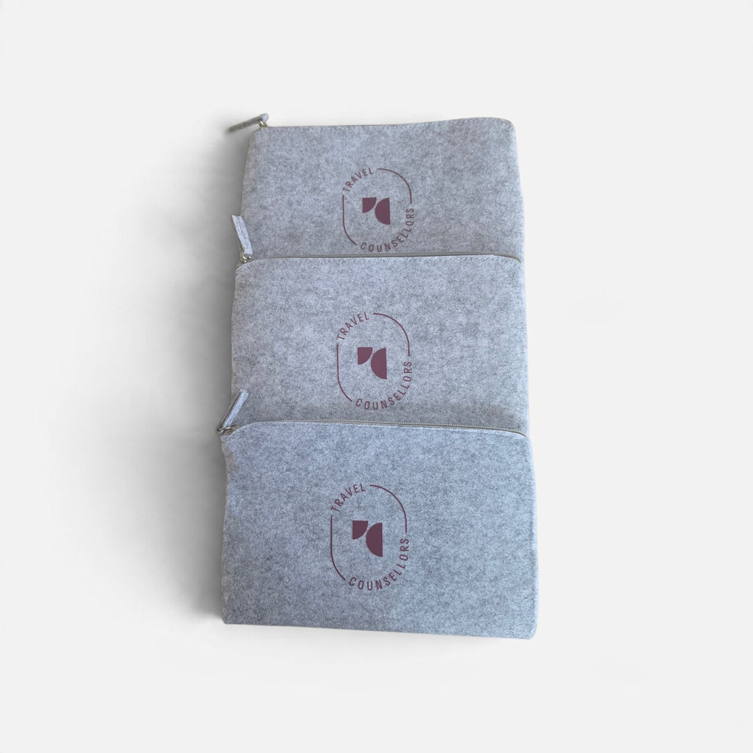 Well Travelled Wallets set of three grey felt zippered travel pouches with Travel Counsellors branding